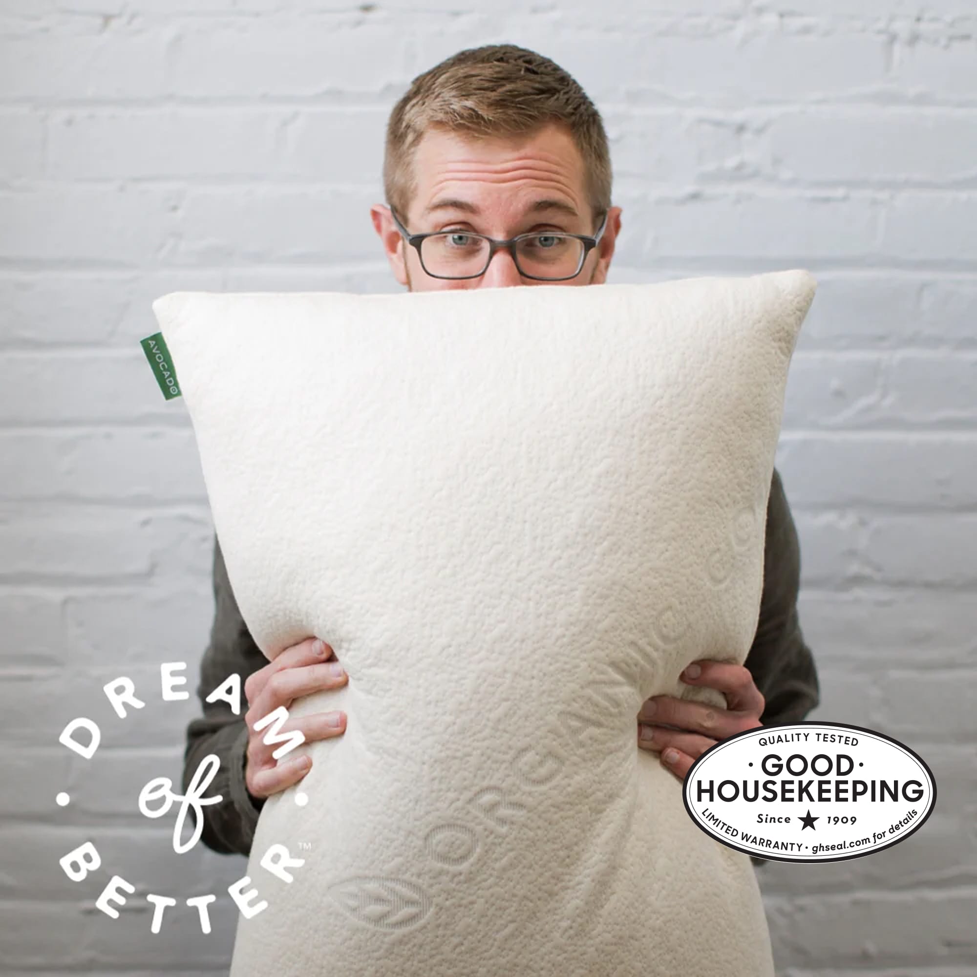 Man holding Avocado Green Pillow image shows Good Housekeeping Seal